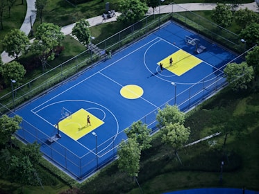 Young basketball players practicing shots on a vibrant court with brand colors.
