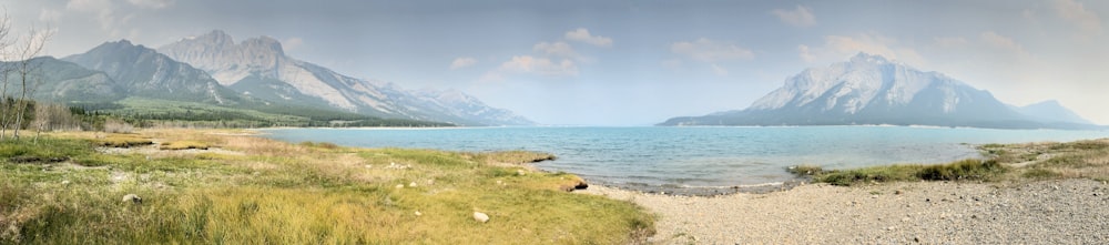 a scenic view of a mountain lake and mountains