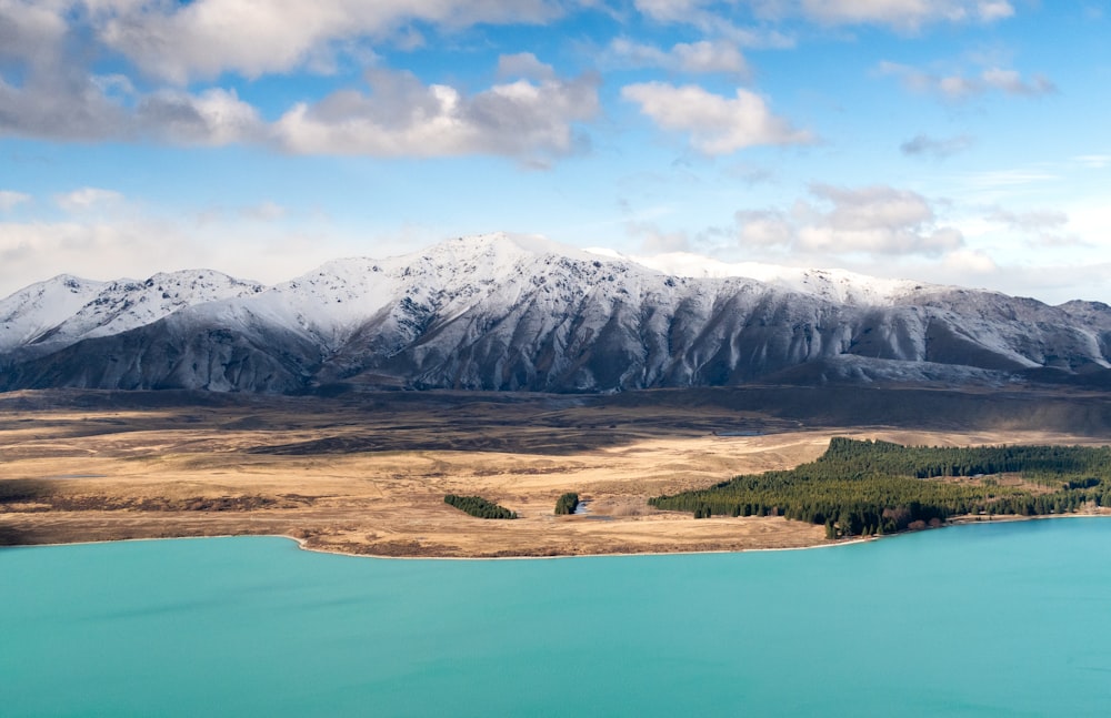 a view of a mountain range with a lake in the foreground