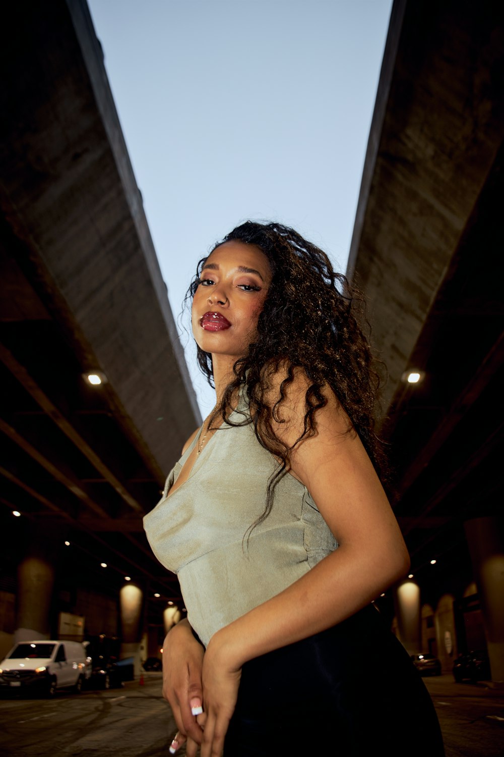 a woman standing in front of a bridge