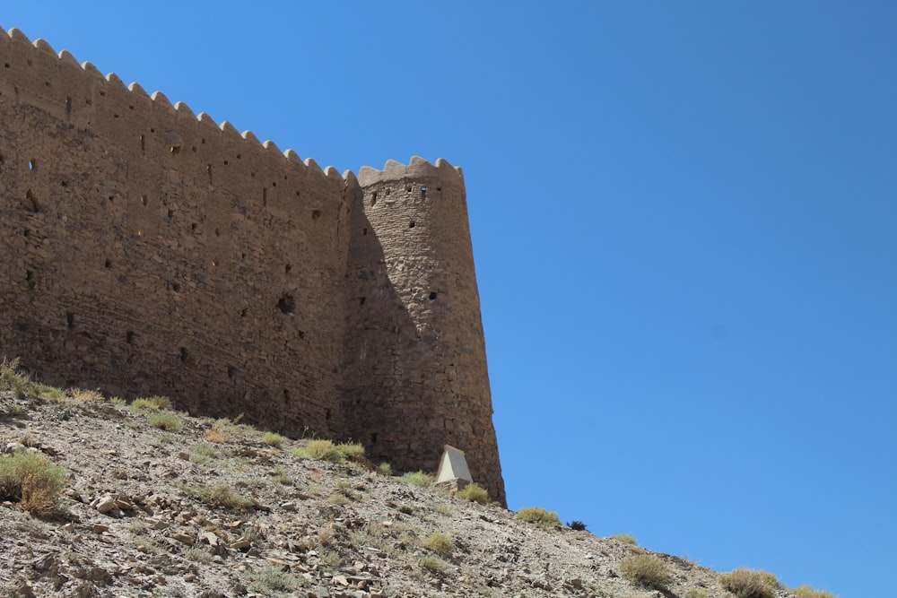 a tall brick building sitting on top of a hill