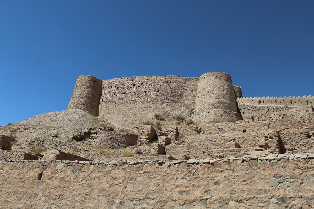 a large stone castle sitting on top of a hill