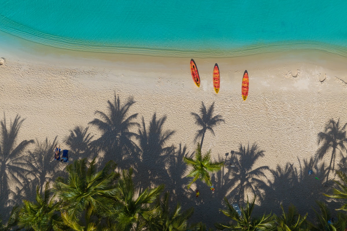 Phu Quoc February — aerial view of white sand beach with kayaks and turquoise water in dry season