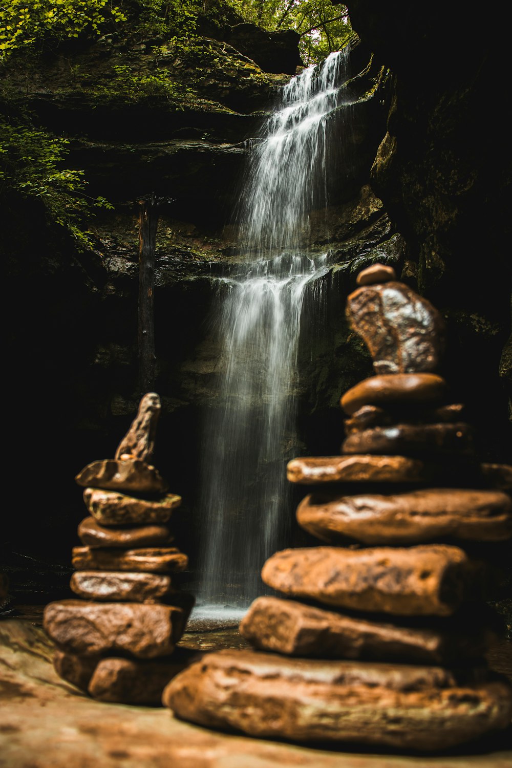 a waterfall with rocks in front of it