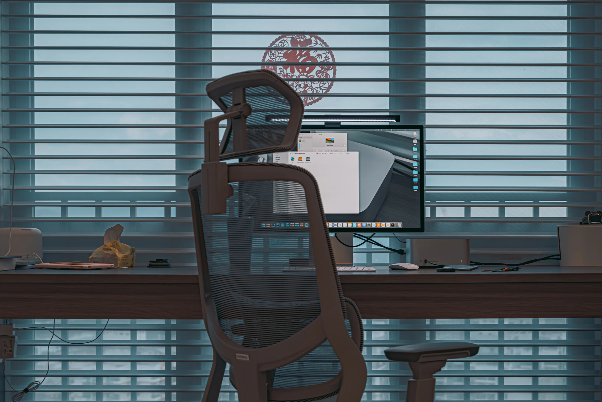 a computer desk with a monitor and a chair