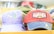 A collection of colorful caps is displayed, each featuring embroidered designs related to San Diego. The caps showcase casual designs with one reading 'San Diego CA' and another featuring a red, white, and blue color scheme with 'San Diego EST 1850' and an illustration of a van.