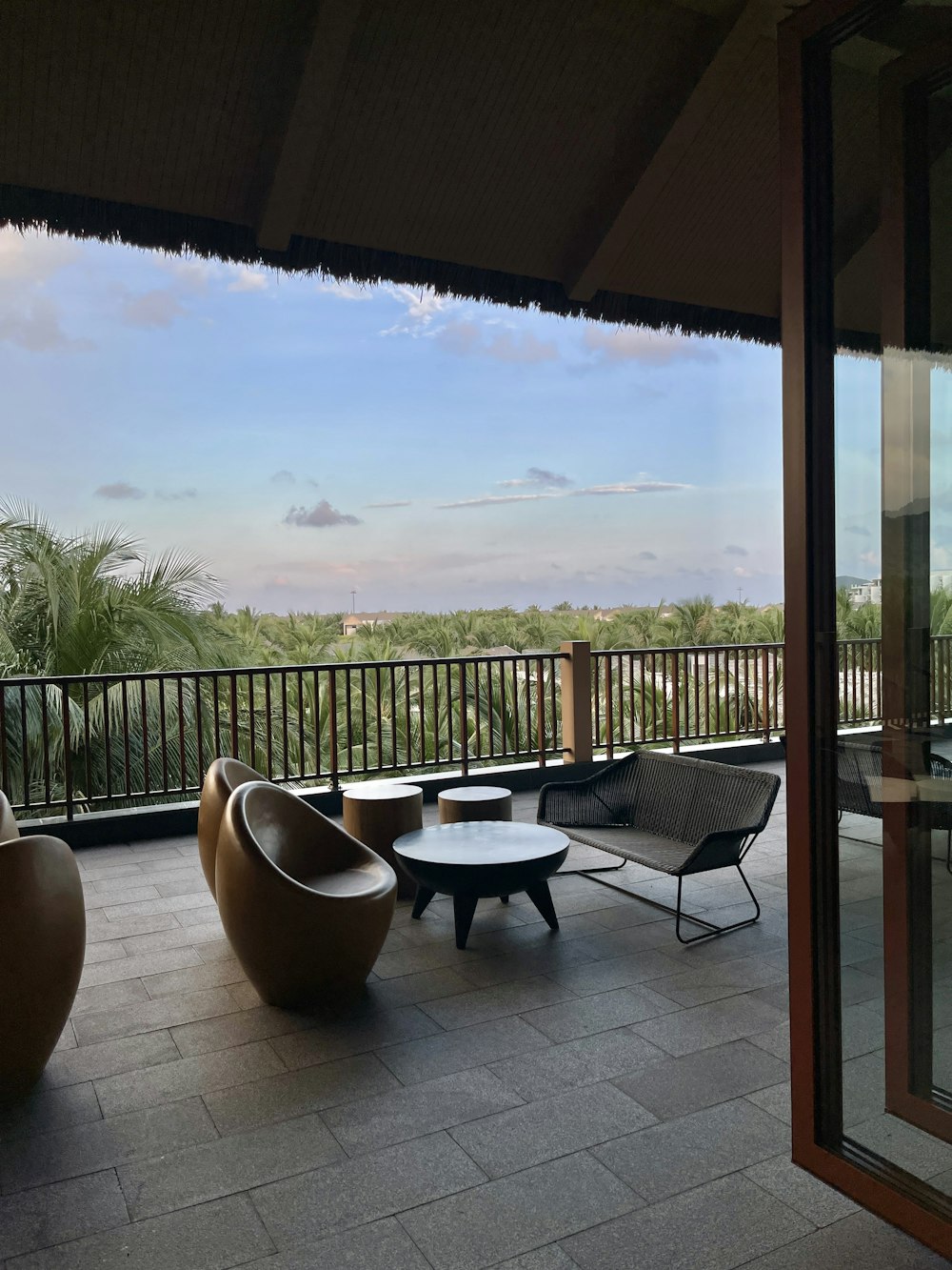 a balcony with a table and chairs and a view