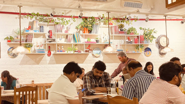 A warm, inviting café scene with diverse people smiling and chatting, symbolizing connection and new friendships.
