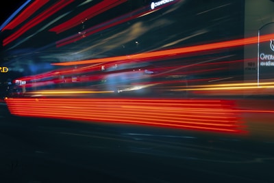 Close-up of a glowing neon map with live delivery routes and holographic data points in an urban setting.