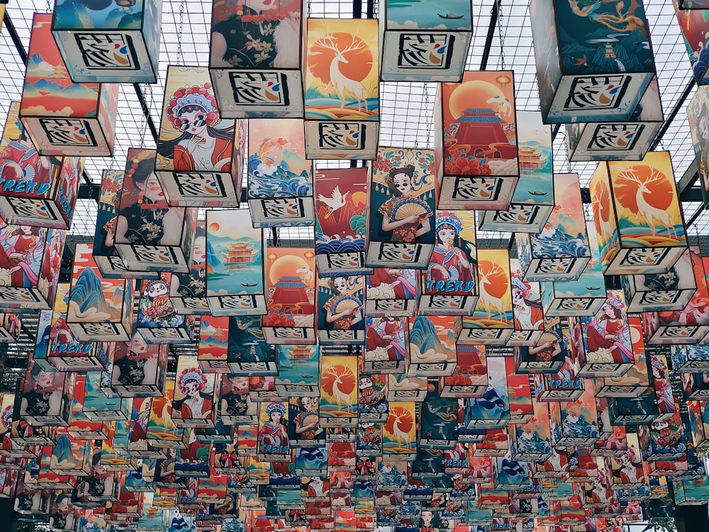 a bunch of pictures hanging from the ceiling of a building