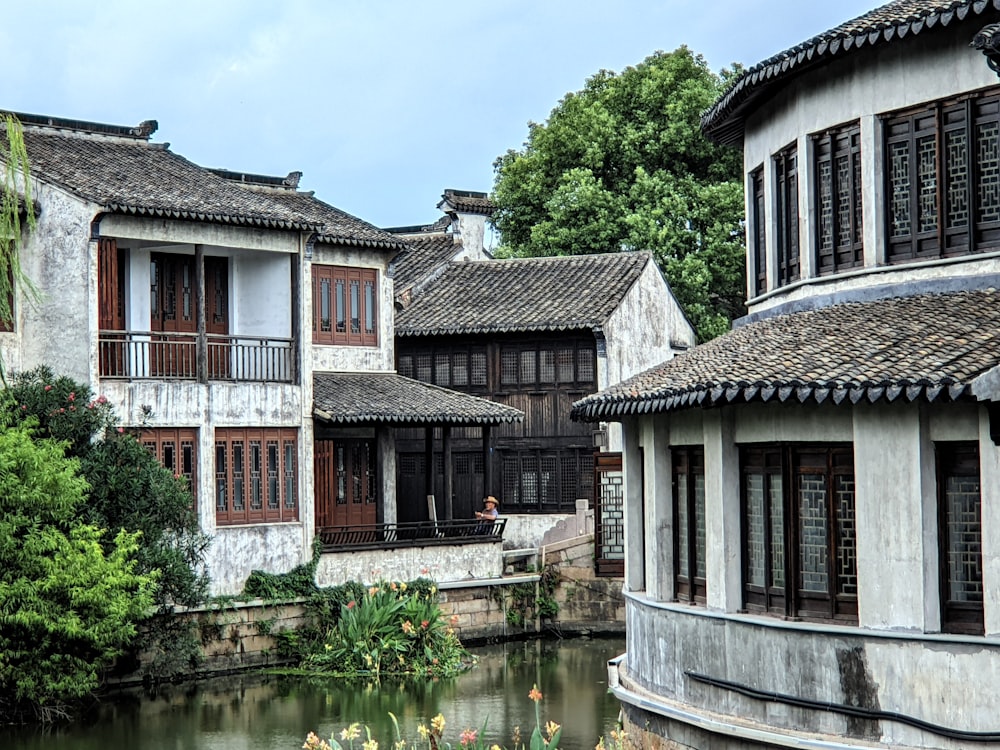 a river running through a small town next to tall buildings