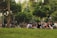 A group of diverse people discussing community issues in a local park.