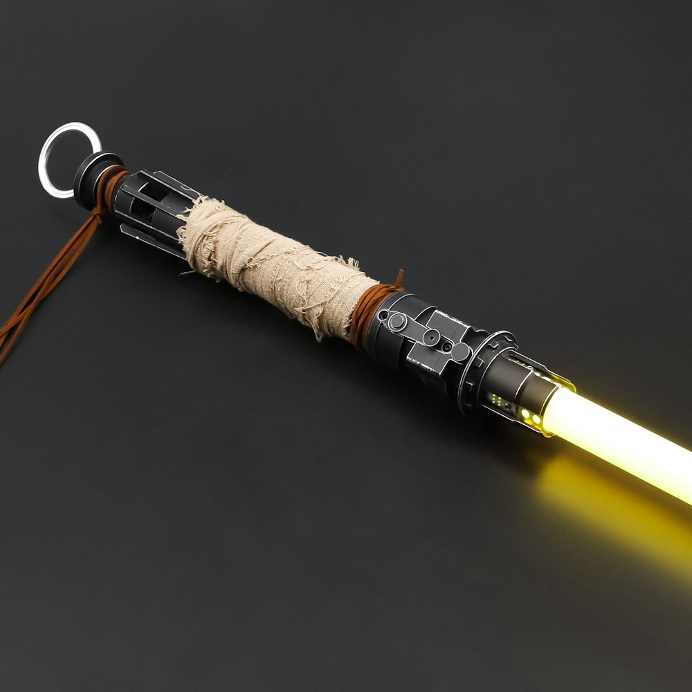 a star wars light saber keychain with a light saber attached to it