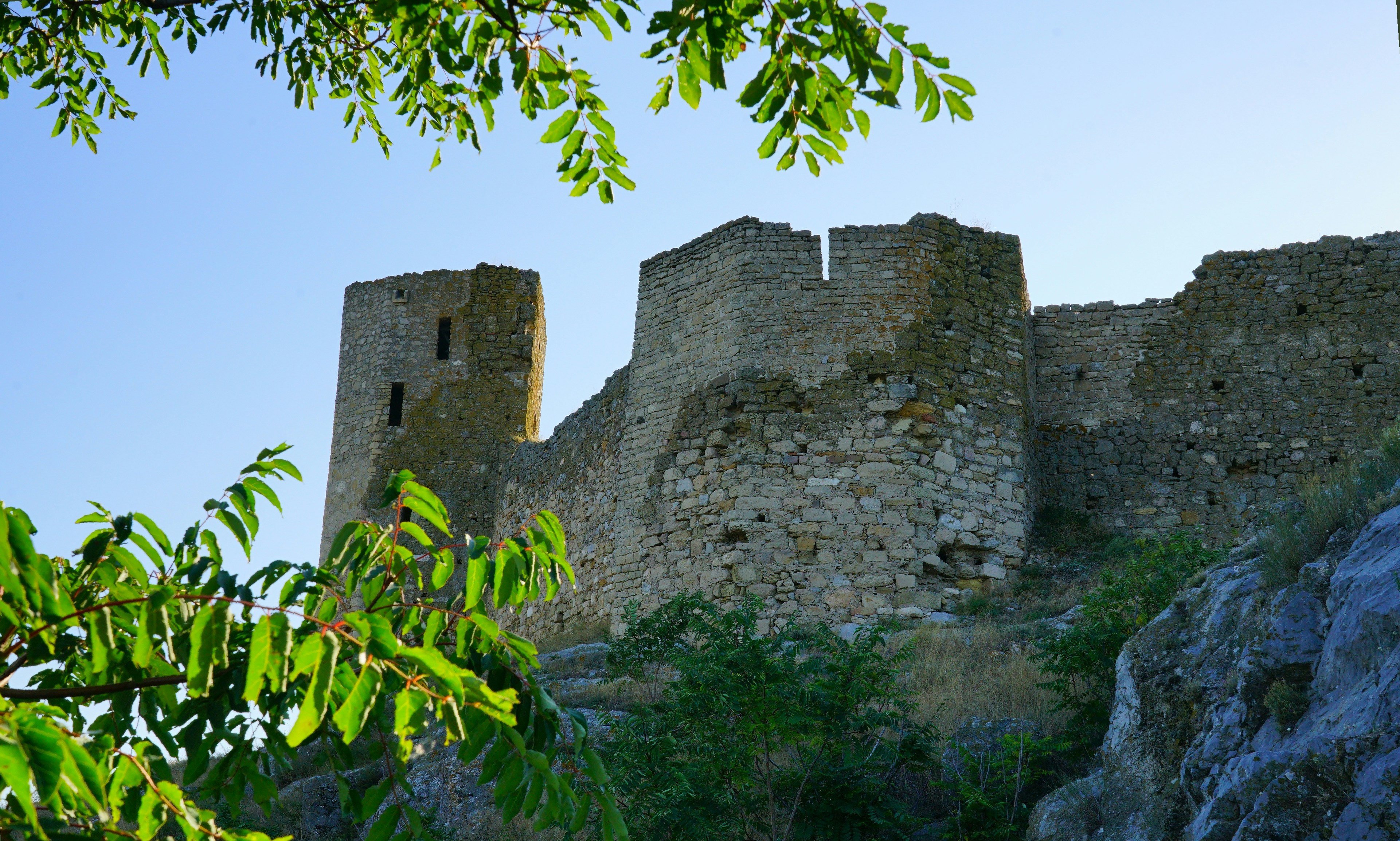 a stone castle sitting on top of a hill