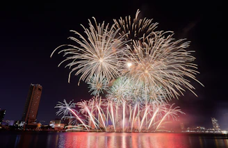 A vibrant grand opening fireworks display lighting up a city skyline at night.