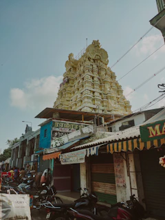 Traditional Madurai street scene with temple tower in background.