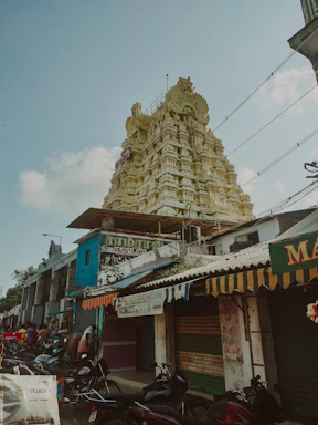 Traditional Madurai street scene with temple tower in background.