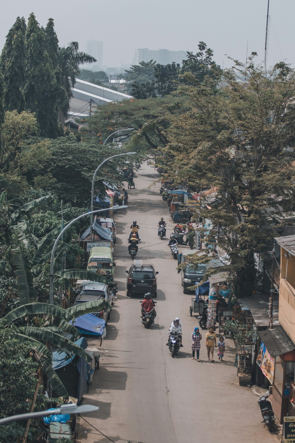 a group of people riding motorcycles down a street