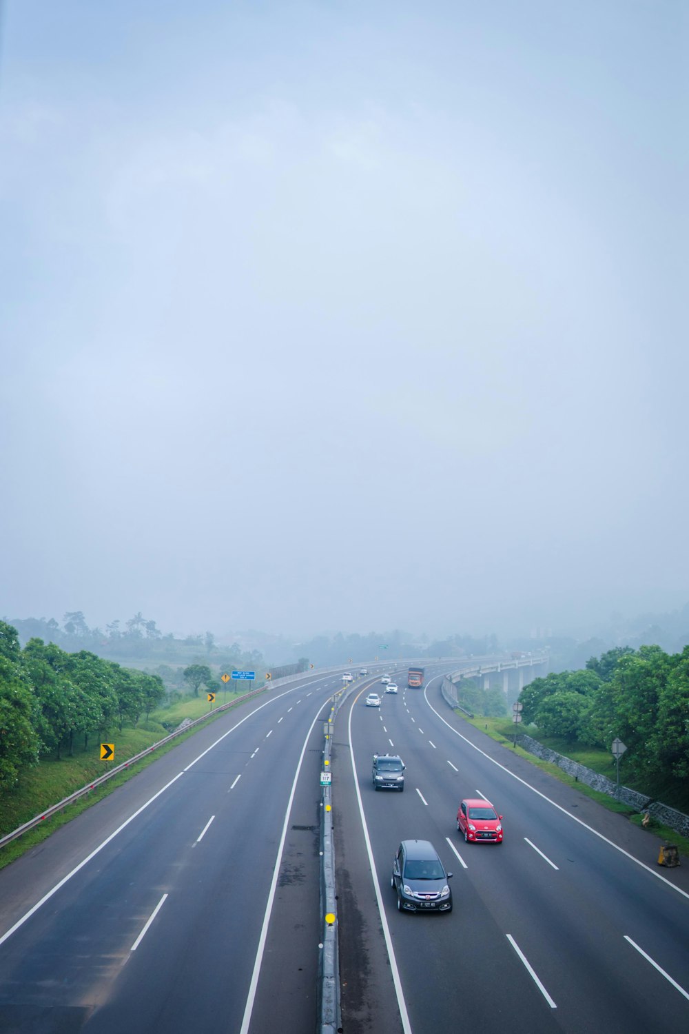 a highway with a few cars driving down it