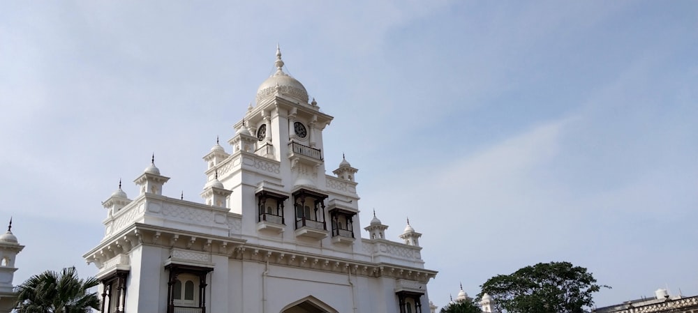 a large white building with a clock tower