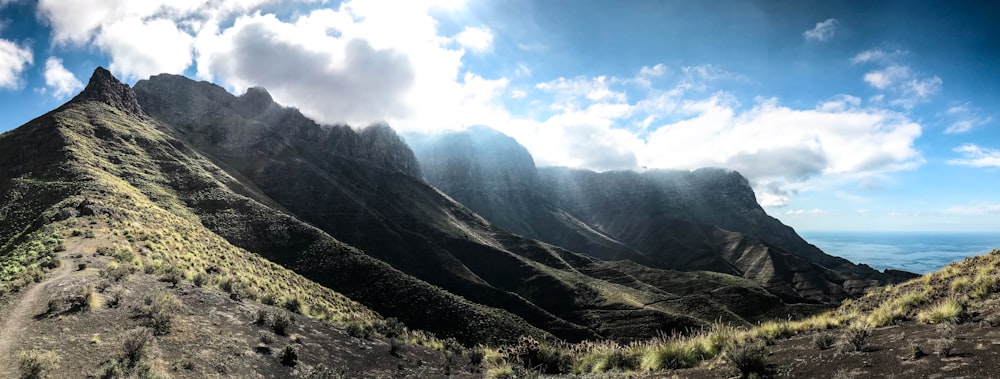 a view of a mountain range with clouds in the sky