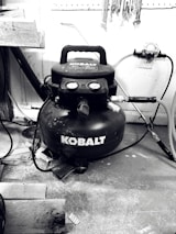 Assorted air compressor spare parts arranged on workshop bench.