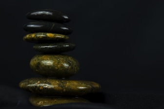 Close-up of hands holding a smooth stone symbolizing emotional balance