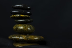 Balanced stack of smooth stones symbolizing harmony and support in a serene office corner.