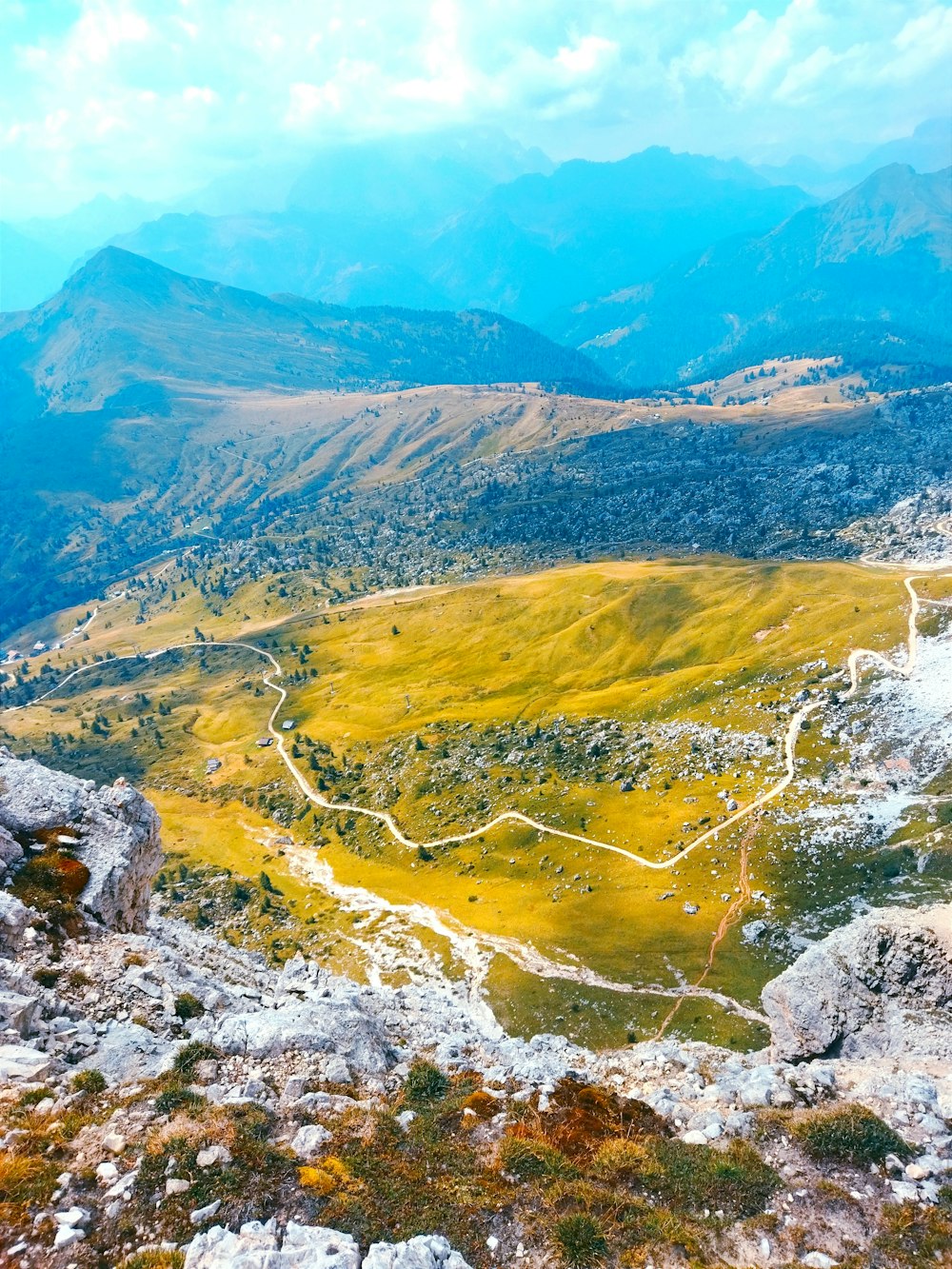 a view of a valley with mountains in the background