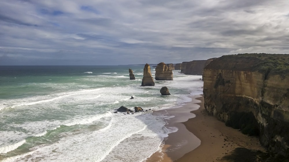 a view of the beach and cliffs of the great ocean road