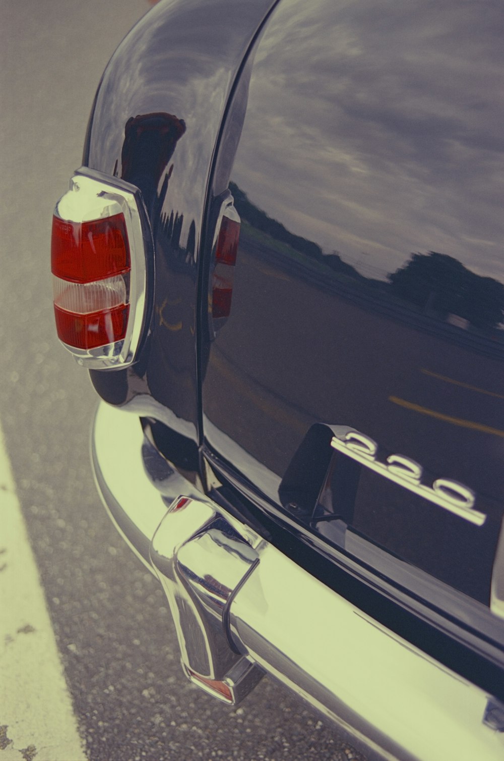 a close up of the tail end of a black car