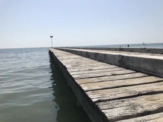 Close-up of the wooden pier at Lobos Island with clear blue skies and calm sea.