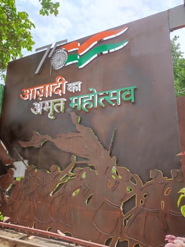 a large metal sign with the indian flag on it