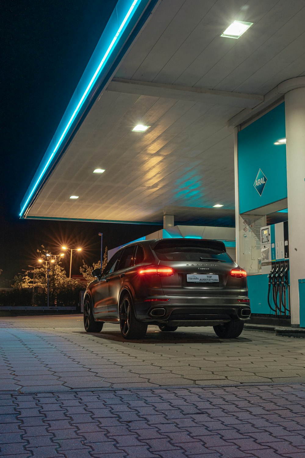 a car parked at a gas station at night