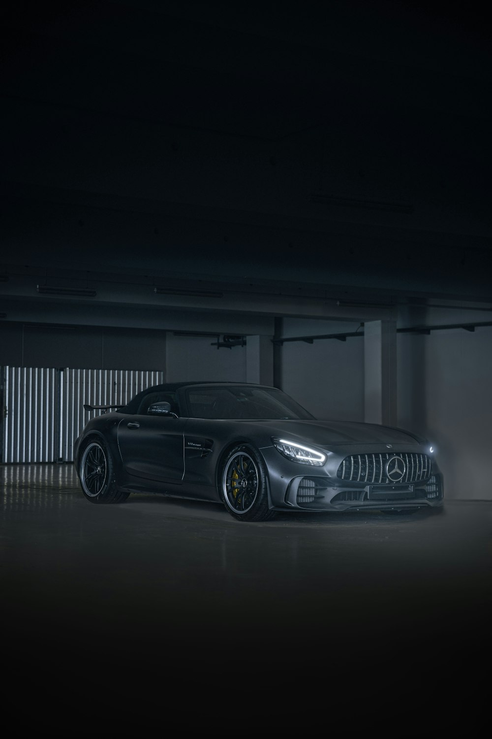 a black sports car parked in a parking garage