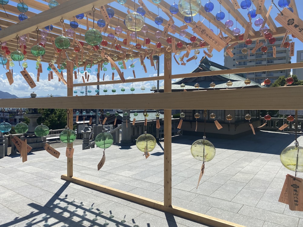 a group of wind chimes hanging from the side of a building
