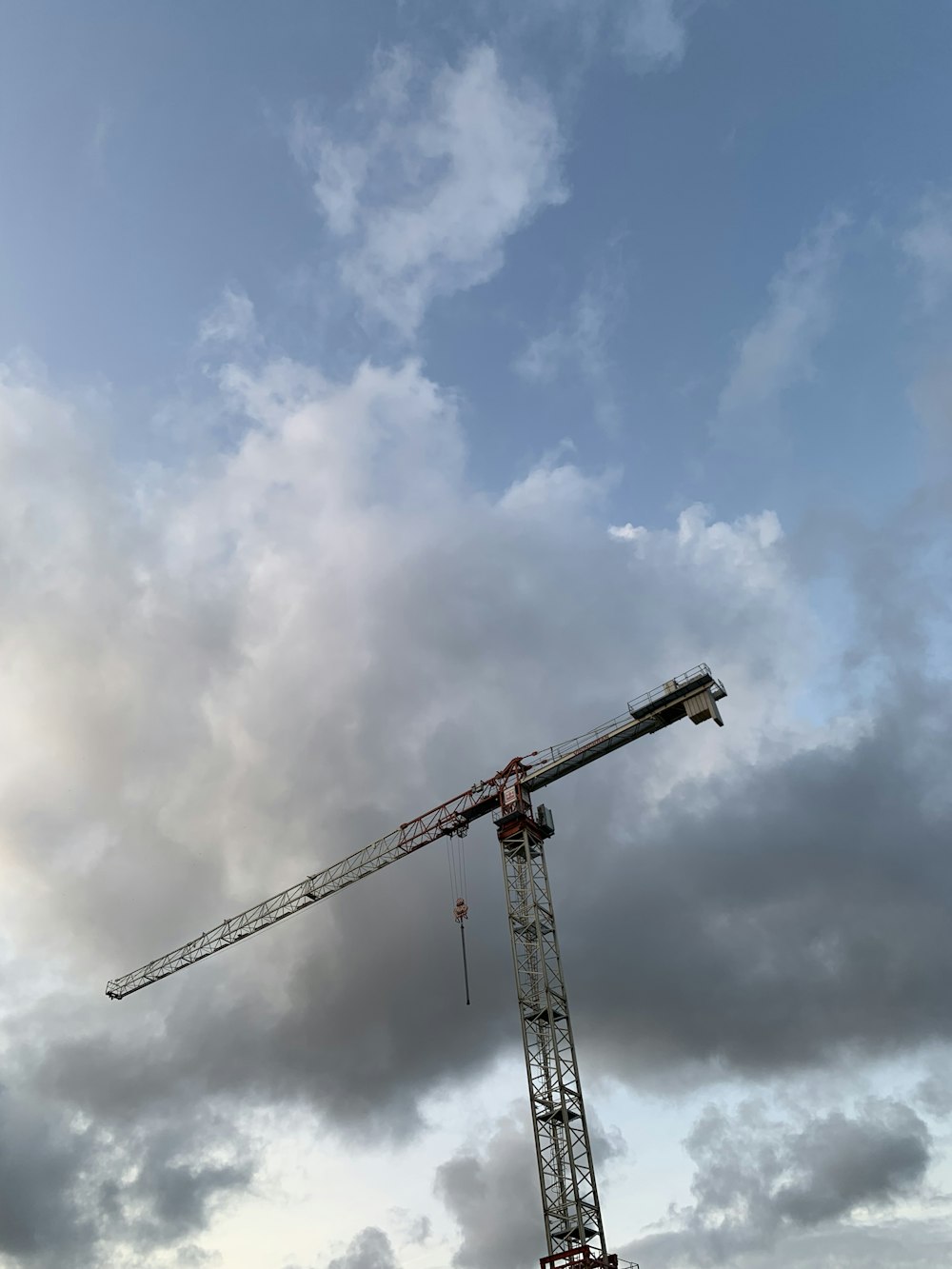 a crane is standing in the middle of a cloudy sky
