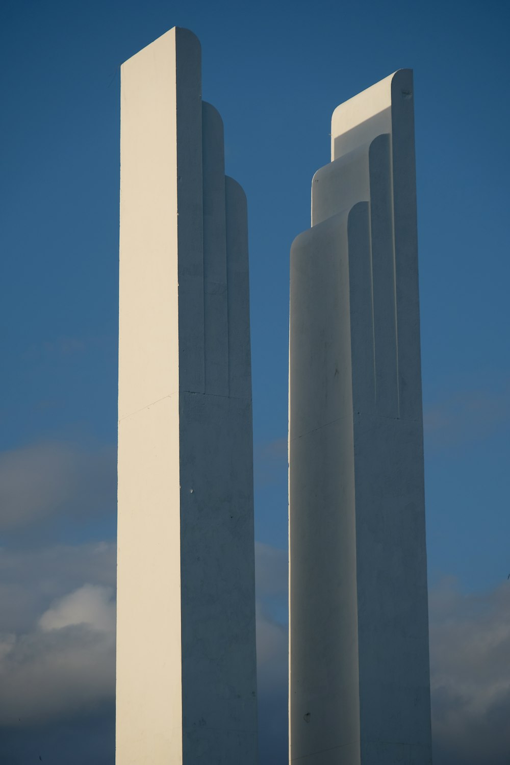a couple of tall white towers sitting next to each other