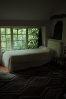A cozy single bed room with modern furnishings and decor.