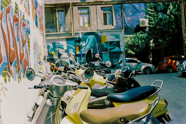 Scooters lined up in front of a charming Lefkada village street.