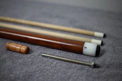 Close-up of a handcrafted cue tip and intricate inlay design on the shaft.