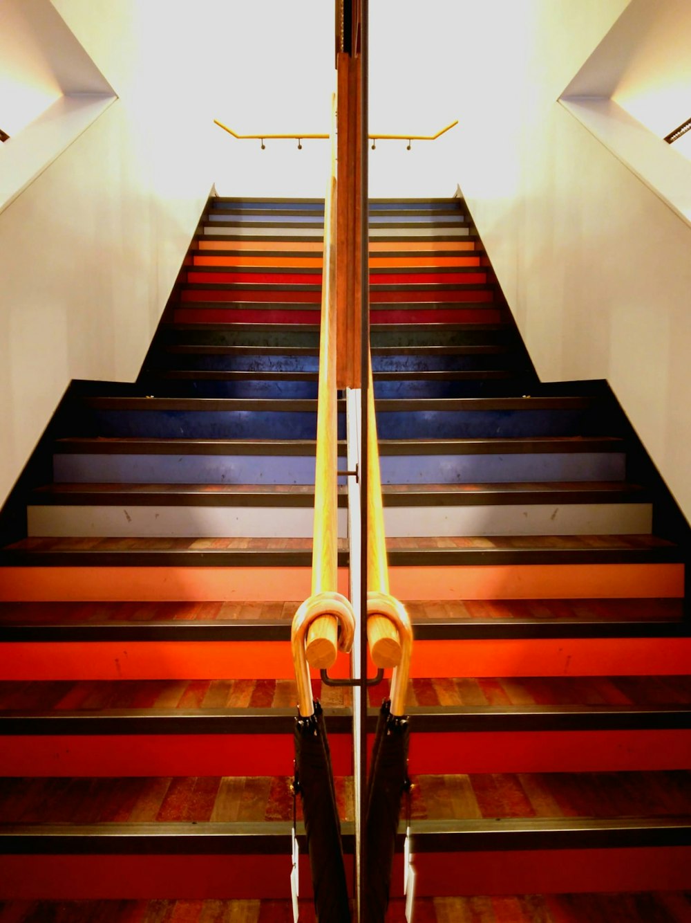 a pair of umbrellas sitting on top of a set of stairs