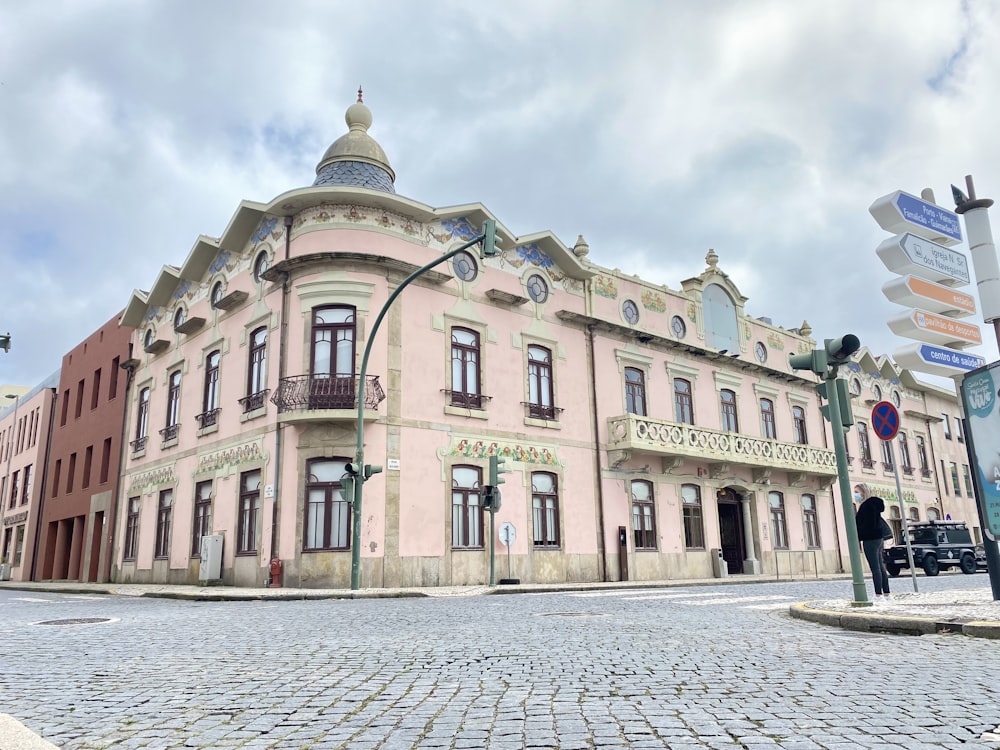 a pink building with a clock on the top of it