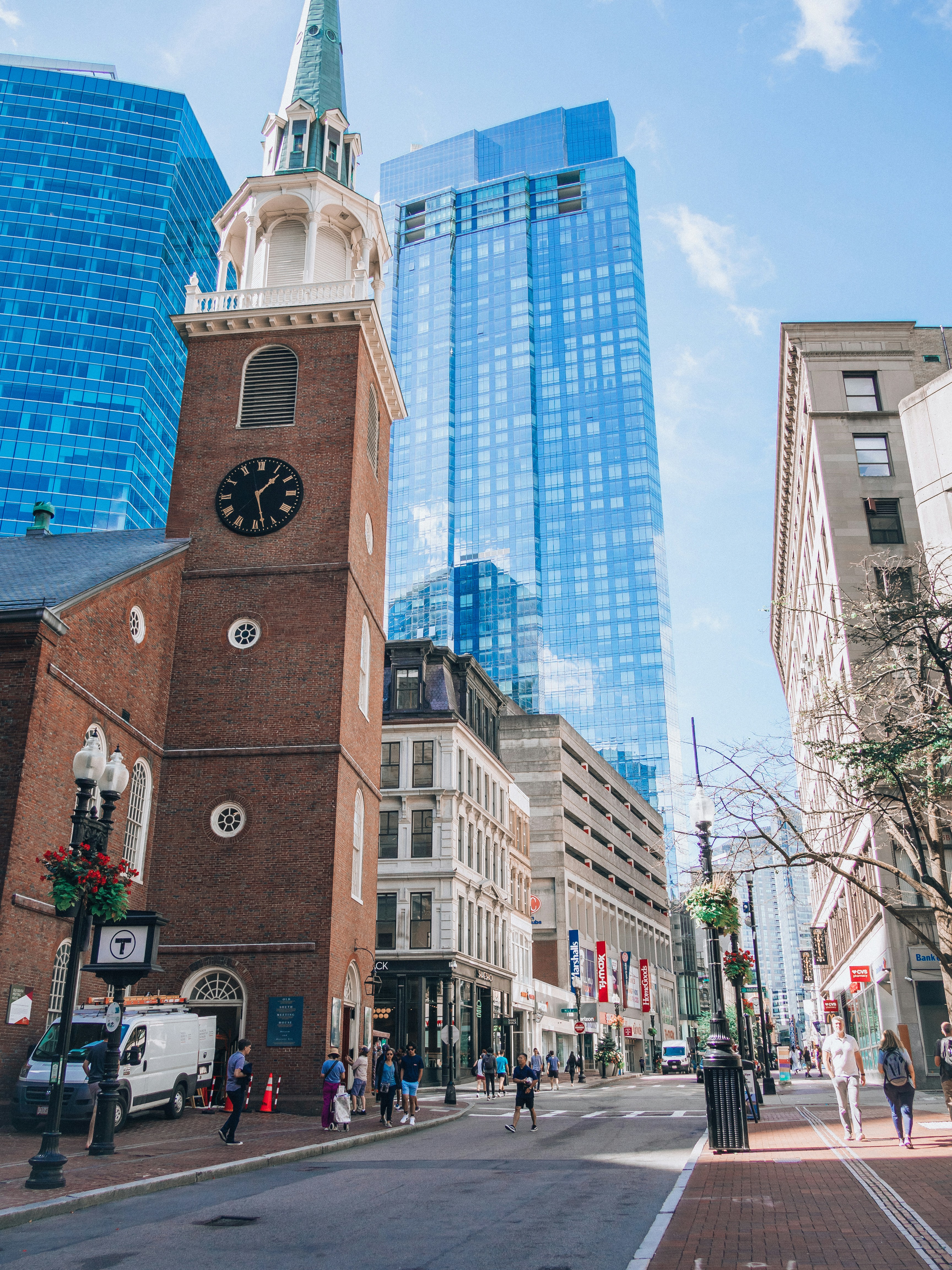 a tall clock tower towering over a city filled with tall buildings