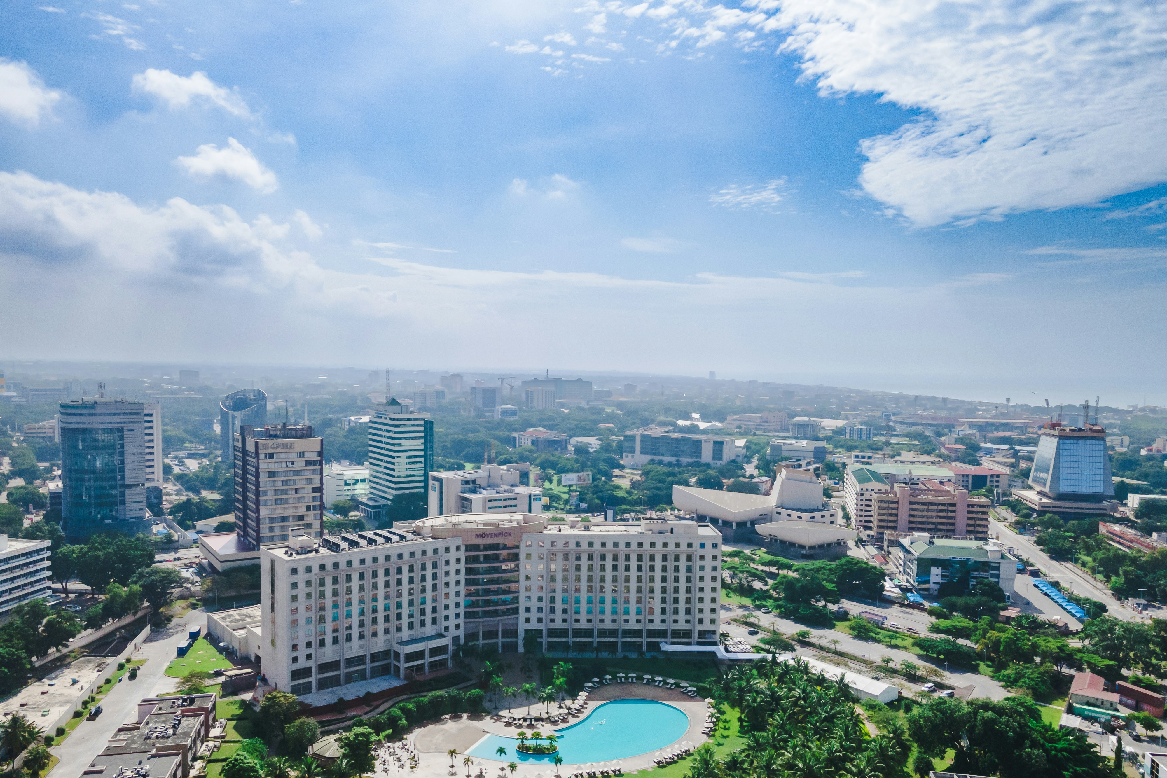 Chennai cityscape aerial view, bright daylight, clear sky, modern urban development visible