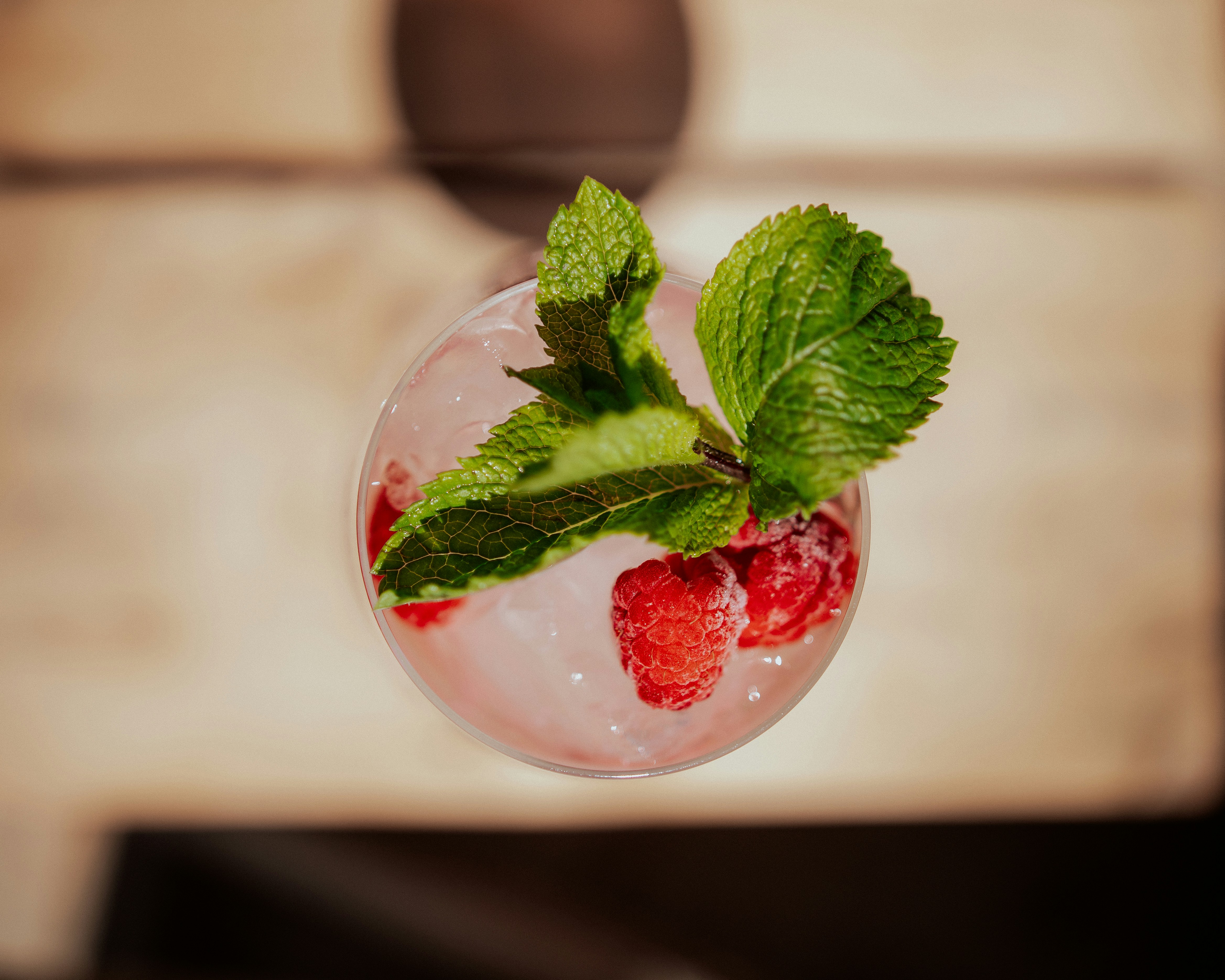 a close up of a drink with strawberries and mint