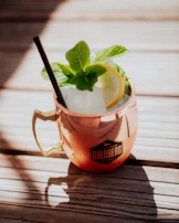 A copper mug catching the sunlight outdoors, emphasizing its rich, glowing color.