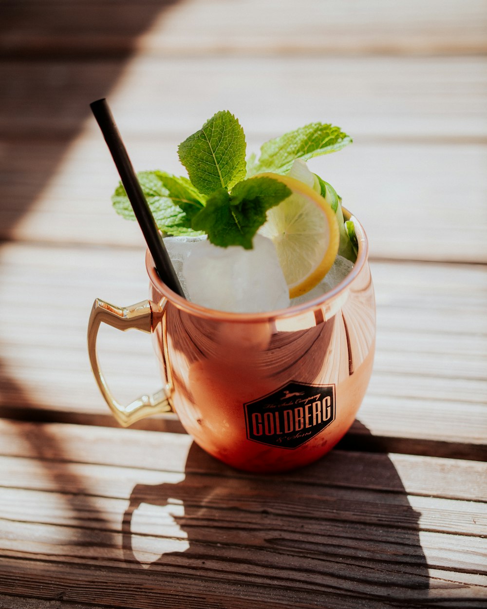 a glass of ice tea with a lemon and mint garnish