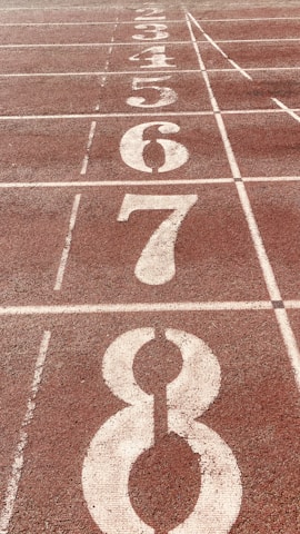 Close-up of a running track surface with lane markings.