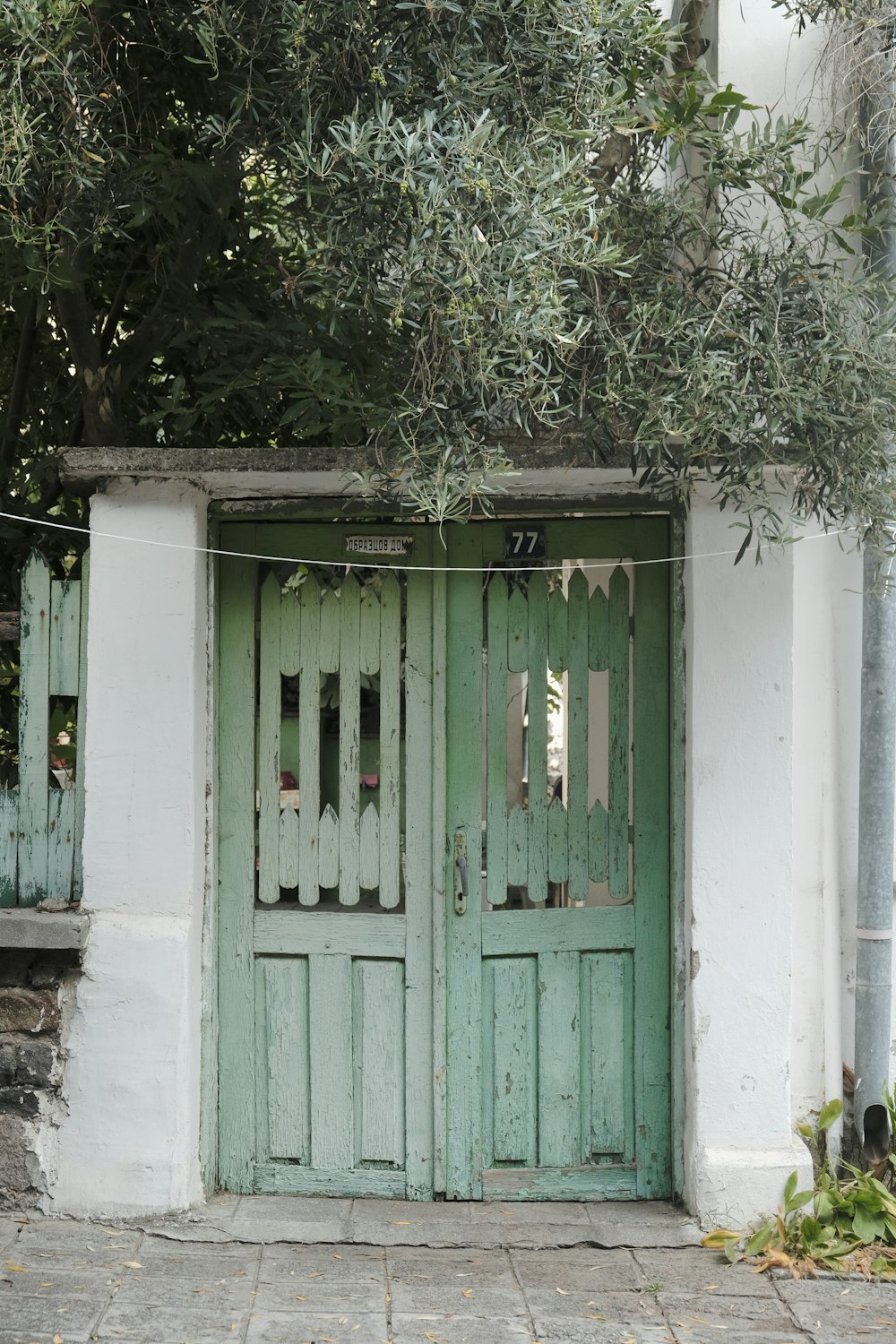 a couple of green doors on a white building